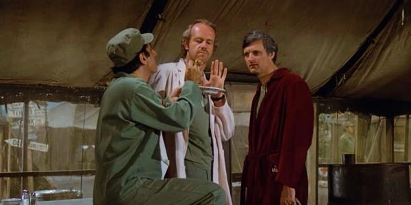 Jamie Farr's Klinger, Mike Farrell's BJ, and Alan Alda's Hawkeye in MASH season 8